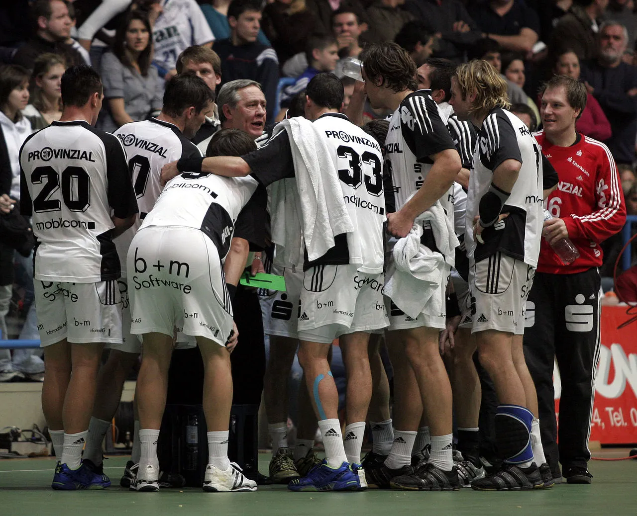 Handball coach talking to his team during a time-out